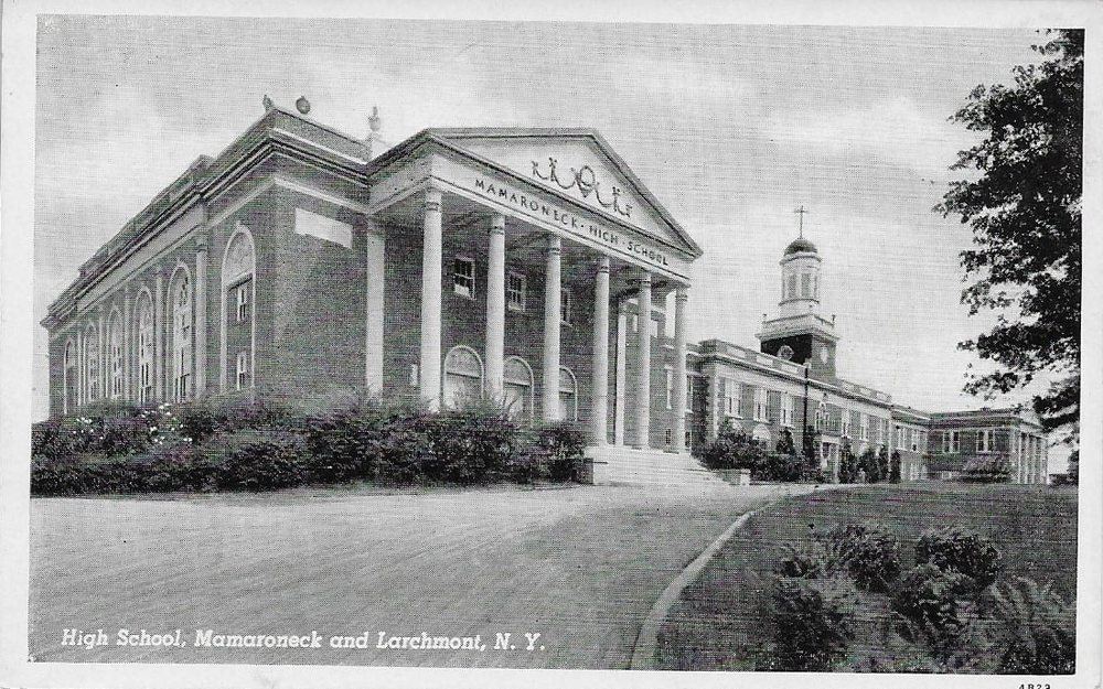 Postcard of Mamaroneck High School's columned front and cupola, with an empty lawn and drive.