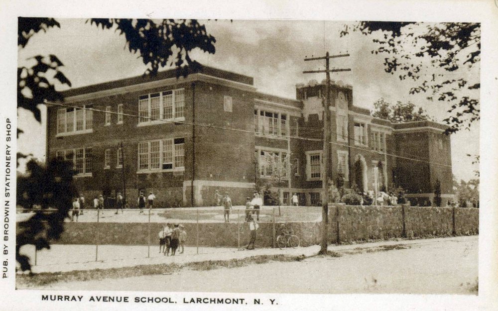 Postcard of Murray Avenue School with children walking in the street out front and no cars.