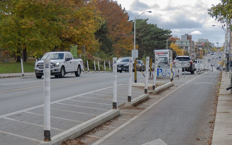 The Bloor Street bike lane in Toronto, separated from traffic by a curb and white posts.